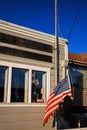 A postal worker raises the American flag