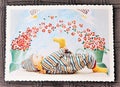 Postcard with a baby lying on a back and smiling