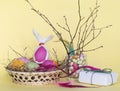 Postcard, bright Easter eggs in a wicker basket with a gift for Easter Royalty Free Stock Photo