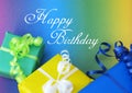 Postcard With Colourful Presents In Yellow Green And Blue And Happy Birthday Script Text