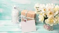 Postcard with daffodils flowers, gift box, candles and empty tag Royalty Free Stock Photo