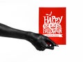 Postcard and Happy Halloween theme: black hand of death holding a paper card with the words Happy Halloween on a white isolated ba