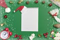 Postcard Happy New Year Flat lay composition with scroll and Christmas decor on green color background. Royalty Free Stock Photo