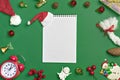 Postcard Happy New Year Flat lay composition with scroll and Christmas decor on green color background. Royalty Free Stock Photo