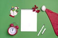 Postcard Happy New Year Flat lay composition with scroll and Christmas decor on green color background. Royalty Free Stock Photo