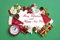 Postcard Happy New Year Flat lay composition with scroll and Christmas decor on green color background. Royalty Free Stock Photo