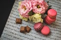 Postcard macaroons and flowers with chocolate, on white paper