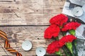 Postcard may 9 - red carnations Ribbon George Old photos on a wooden background. Symbol of victory in the great Patriotic war Royalty Free Stock Photo