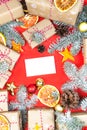 Postcard mockup with many presents and christmas decor on red background. Greetings zero waste template Royalty Free Stock Photo