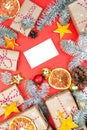Postcard mockup with many presents and christmas decor on red background. Greetings zero waste template Royalty Free Stock Photo