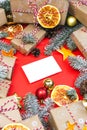 Postcard mockup with many presents and christmas decor on red background. Greetings zero waste template Royalty Free Stock Photo