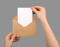 Postcard mockup, vertical blank card taking from paper envelope  on white Royalty Free Stock Photo