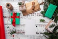 Postcard and pen lie on a wooden table next to gifts