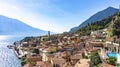 Postcard scenic panoramic view of the old European town on the shore of a mountain lake. City of Limone sul Garda aerial view. Royalty Free Stock Photo