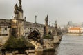 Postcard view of Charles Bridge and Lesser Town in mist,Czech republic.Famous tourist destination.Prague panorama.Foggy morning in Royalty Free Stock Photo