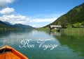 Postcard with a wonderfully panorama view with a turquoise blue austrian lake with green mountains and wooden houses