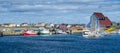 Postcards from Bonavista, Newfoundland fishing villages see boats at rest for the day on calm coastal water.
