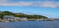 Postcards from Bonavista, Newfoundland fishing villages see boats at rest for the day on calm coastal water.