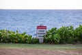 Posted sign on an edge of a cliff read `Caution` and ` Loose slippery rocks`