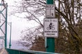 Posted signs `Bell or Yell` and `Keep Right` on an entry to Lions Gate bridge, Vancouver, BC, Canada