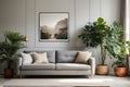 Poster above white cabinet with plant next to grey sofa Royalty Free Stock Photo