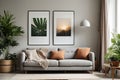 Poster above white cabinet with plant next to grey sofa Royalty Free Stock Photo