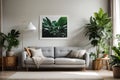 Poster above white cabinet with plant next to grey sofa