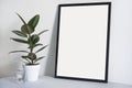 Poster in black frame in nordic stylish modern interior, ficus, living room. Empty space for design layout