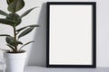 Poster A1 in black frame in nordic stylish modern interior, grey armchair, ficus, living room. Empty space for design layout