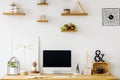 Poster and desktop computer on wooden desk in white home office Royalty Free Stock Photo