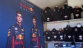 With a poster of drivers Daniel Ricciardo and Max Verstappen, Red Bull Formula 1 merchandise takes center stage.