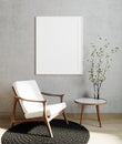 . Poster frame mock up in modern living room interior background with white armchair and gray wall, minimalistic scandinavian Royalty Free Stock Photo