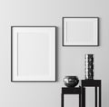 Poster frame mockup with modern decor on empty white wall background Royalty Free Stock Photo