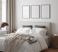 Poster frame mockup in white cozy bedroom interior with double bed
