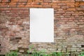 Poster glued to old brick wall. Blank, clean white paper for mockup