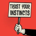 Poster in hand, business concept with text Trust Your Instincts