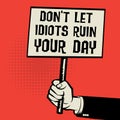 Poster in hand, text Don`t Let Idiots Ruin Your Day Royalty Free Stock Photo