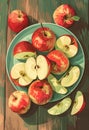 Poster with juicy ripe apples on a plate on a wooden table