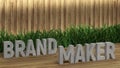 Poster lettering Brandmaker. Large letters on a wooden table. Modern decorative grass, backlit wall of wooden battens. Great loft