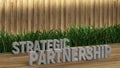 Poster lettering Strategic partnership. Large letters on a wooden table. Modern decorative grass, backlit wall of wooden battens.