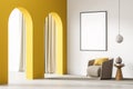 Poster in the light beige room corner with yellow arches and armchair Royalty Free Stock Photo