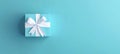Poster mockup with a baby blue gift box with white bow on a light blue background. 3D Rendering, 3D Illustration Royalty Free Stock Photo