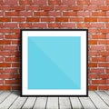 Poster mockup template with black frame hanging on red brick wall