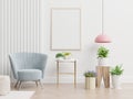 Poster mockup with two vertical frames on empty white wall in living room interior with blue velvet armchair Royalty Free Stock Photo