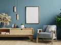 Poster mockup with vertical frames on empty dark green wall in living room interior with blue velvet armchair Royalty Free Stock Photo