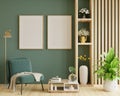 Poster mockup with vertical frames on empty dark green wall with green velvet armchair Royalty Free Stock Photo