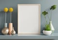 Poster mockup with wooden frame in home interior on blue wall background Royalty Free Stock Photo