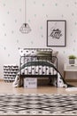Poster in patterned child`s bedroom