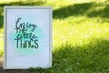 Poster with phrase Enjoy The Little Things on grass outdoors, space for text