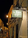 Poster pizzeria in a European street at night.